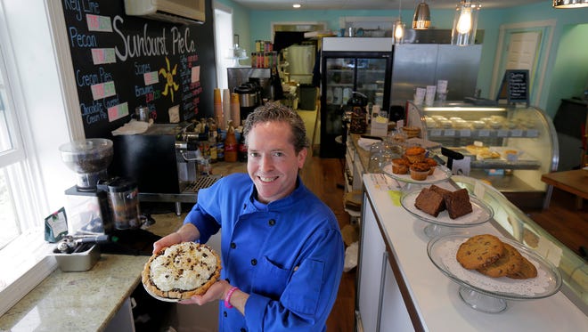 Jay McConville, owner of Sunburst Pie Co., holds a chocolate-covered coconut cream pie at his Manasquan bakery.