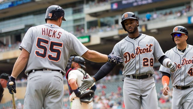 Niko Goodrum (28) celebrates with  John Hicks after hitting a home run in the fourth inning Wednesday.