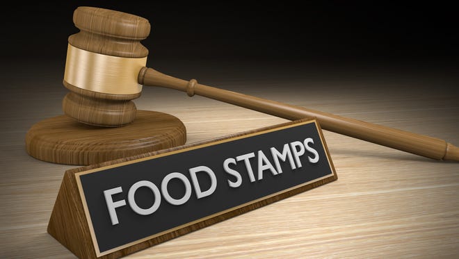 3D render of a wood court gavel lying next to a sign that says food stamps.