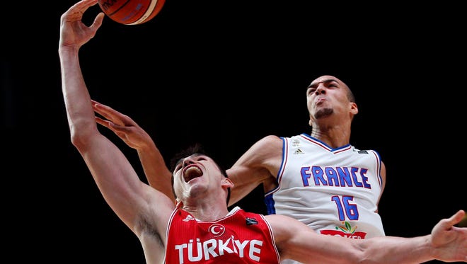 Turkey's Ersan Ilyasova in action against France's Rudy Gobert during the EuroBasket Round of 16 match at the Pierre Mauroy Stadium on Saturday.