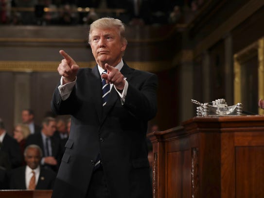 President Trump reacts after delivering his first address