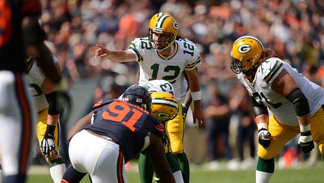 Green Bay Packers quarterback Aaron Rodgers (12) shouts instructions to his teammates at the line of scrimmage during Sunday's game against the Chicago Bears at Soldier Field.