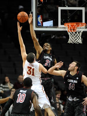 South Carolina forward/center Demetrius Henry (21) blocks a shot by Iowa State forward Georges Niang (31) as South Carolina's guard Duane Notice (10) and forward Laimonas Chatkevicius (14) defend during the first half of Saturday's game at the Barclays Center in Brooklyn, N.Y.