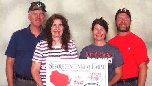 Chuck and Carla Kuhrt and Jenny and Joe Sonnleitner received the Sesquicentennial Farm designation at the Wisconsin State Fair.