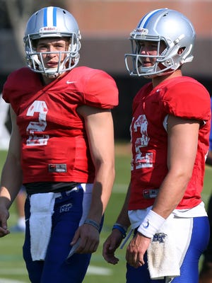 Despite being best friends off the field, MTSU quarterbacks Austin Grammer (2) and Brent Stockstill (12) are battling for the Blue Raiders' starting quarterback job during spring practice this month.