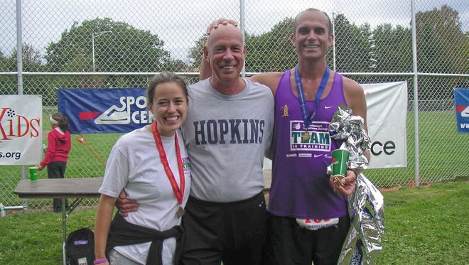 Ed Sponseller, middle, poses for a photo at the 2006 Maine Marathon with his son, Steve Sponseller, and his son's wife, Amy. Ed participated in some of the race the same year he was diagnosed with lymphoma.