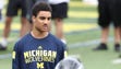 Michigan player Nate Johnson works with high school