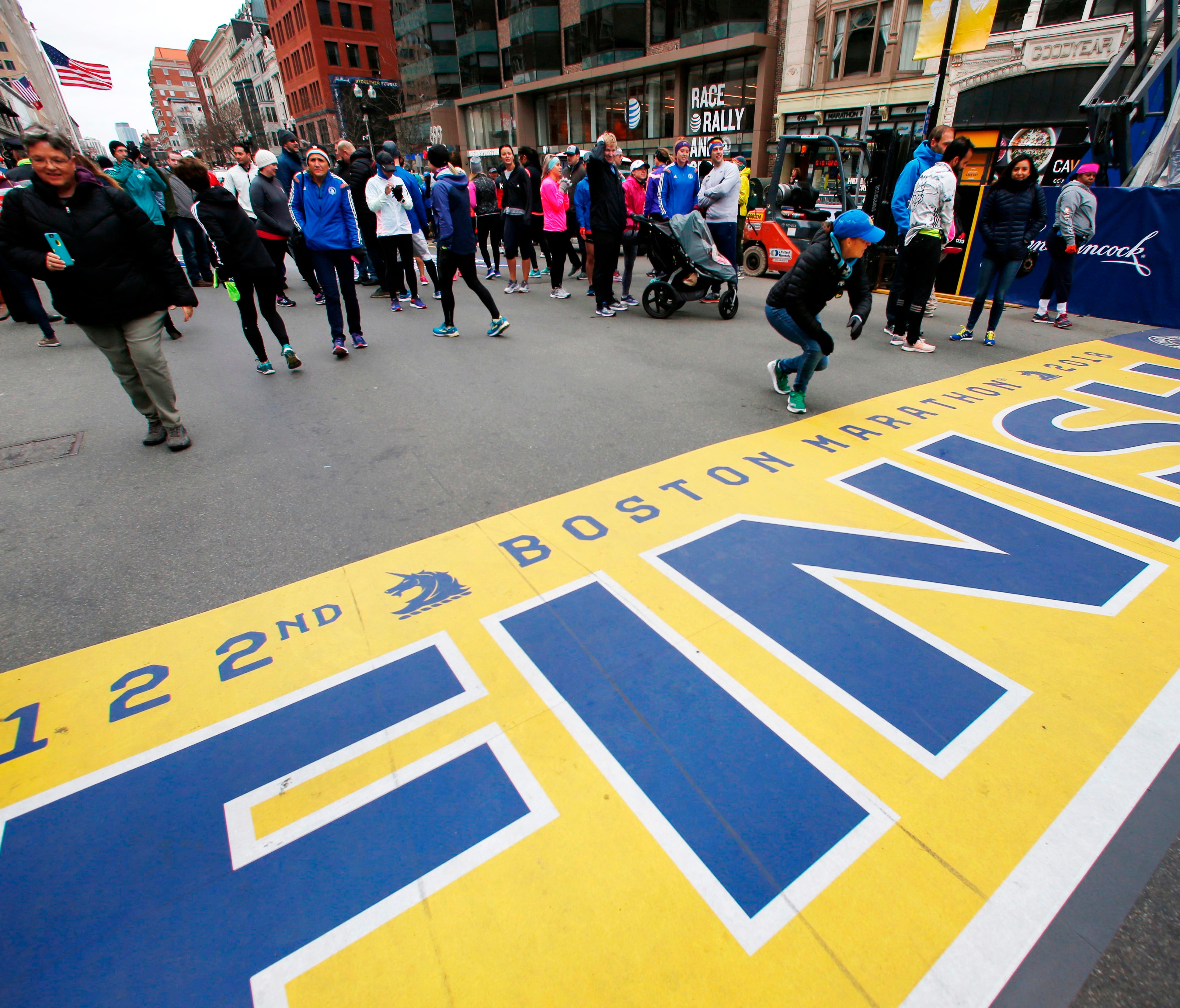 People gather at the Boston Marathon finish line in Boston on April 15 ahead of Monday's race.