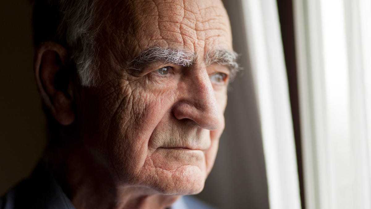 Closeup of an older person with a serious expression.