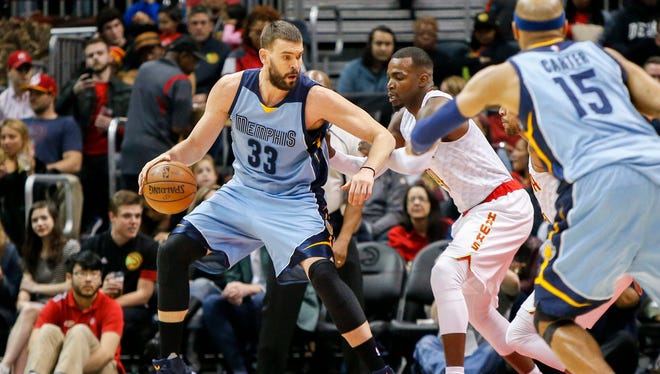 Memphis Grizzlies center Marc Gasol (33) dribbles the ball as Atlanta Hawks forward Paul Millsap (4) defends in the second quarter at Philips Arena.