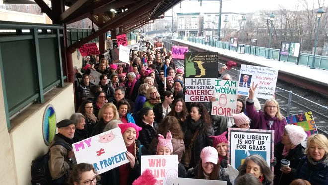 Members of Montclair-based BlueWave NJ wait for the train at the Bay Street station to take them to New York City for the NYC Women's March on Saturday, Jan. 21.