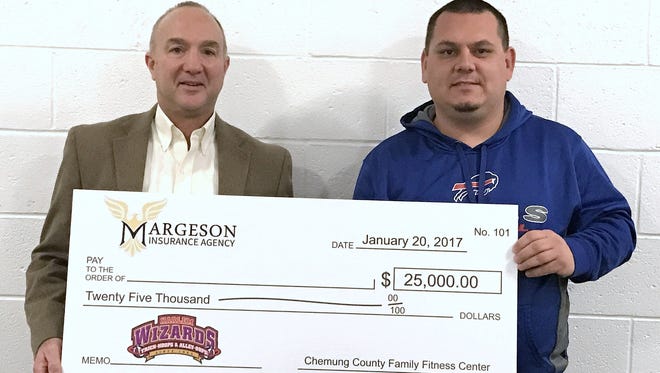 Margeson Insurance Agency owner Mark Margeson, left, and Chemung County Family Fitness Center Director Bob Townson show off a $25,000 check that a lucky fan might win during the Jan. 20 Harlem Wizards basketball game.