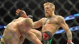 McGregor lands a knee against Dennis Siver during their