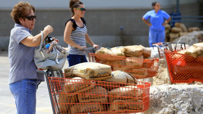 Residents wait with sandbags as Hurricane Harvey approaches Corpus Christi, Texas.