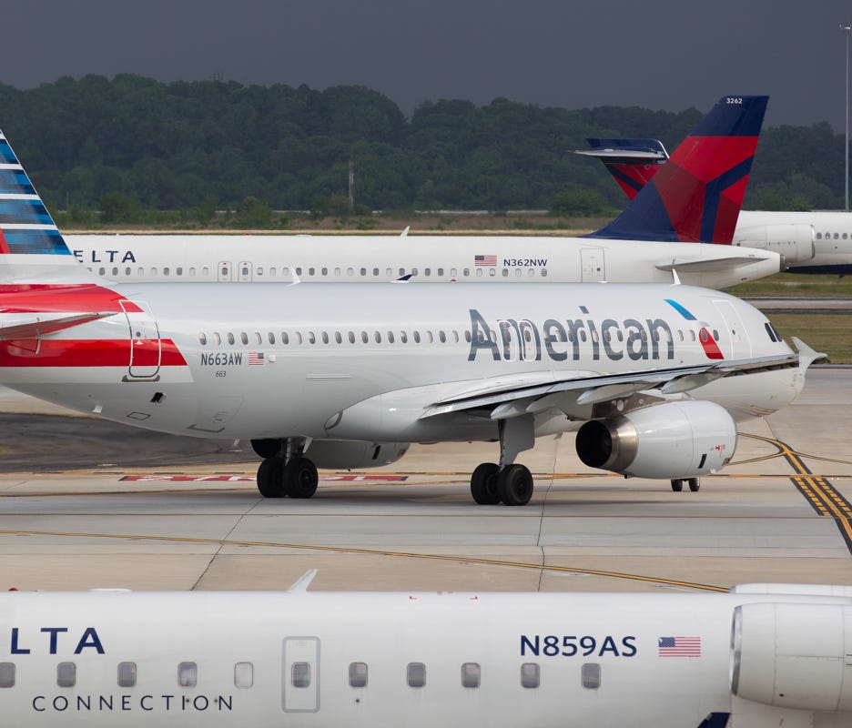 Surrounded by Delta Air Lines jets, an American Airlines Airbus A320 taxis out for departure on April 30, 2016, in Atlanta.