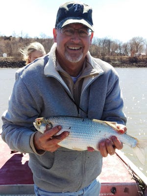 Brent Newton of Holts Summit holds his 2-pound record goldeye fish he caught on the Osage River.