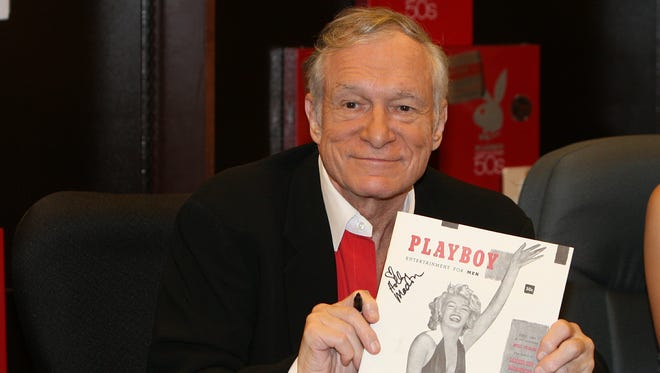 In this 2007 photo, Hugh Hefner smiles while signing copies of the Playboy calendar and "Playboy Cover To Cover: The 50's" DVD box set in Los Angeles. The Playboy founder died at age 91, his company announced Wednesday, Sept. 27, 2017.