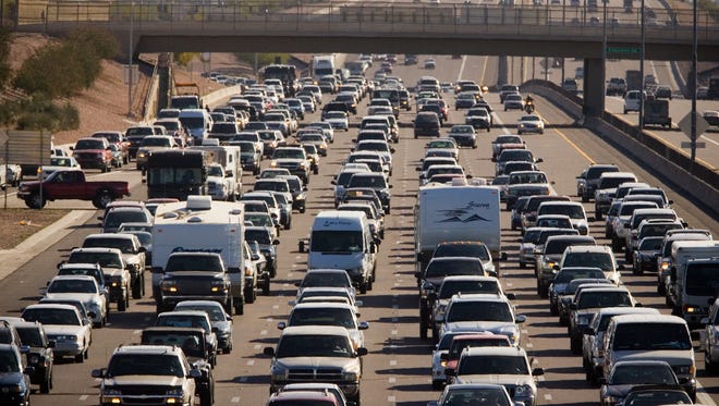 Traffic is severely backed up on Westbound U.S. 60 east of Loop 101 in Mesa on Friday, February 27, 2009. The freeway was closed after a woman crawled into the carpool lane and was struck and killed.