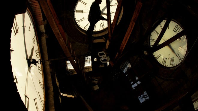 Custodian Ray Keen checks the time on a clock face after changing the time on the 97-year-old clock atop the Clay County Courthouse. The Georgia General Assembly is considering a bill that would abolish daylight savings time.