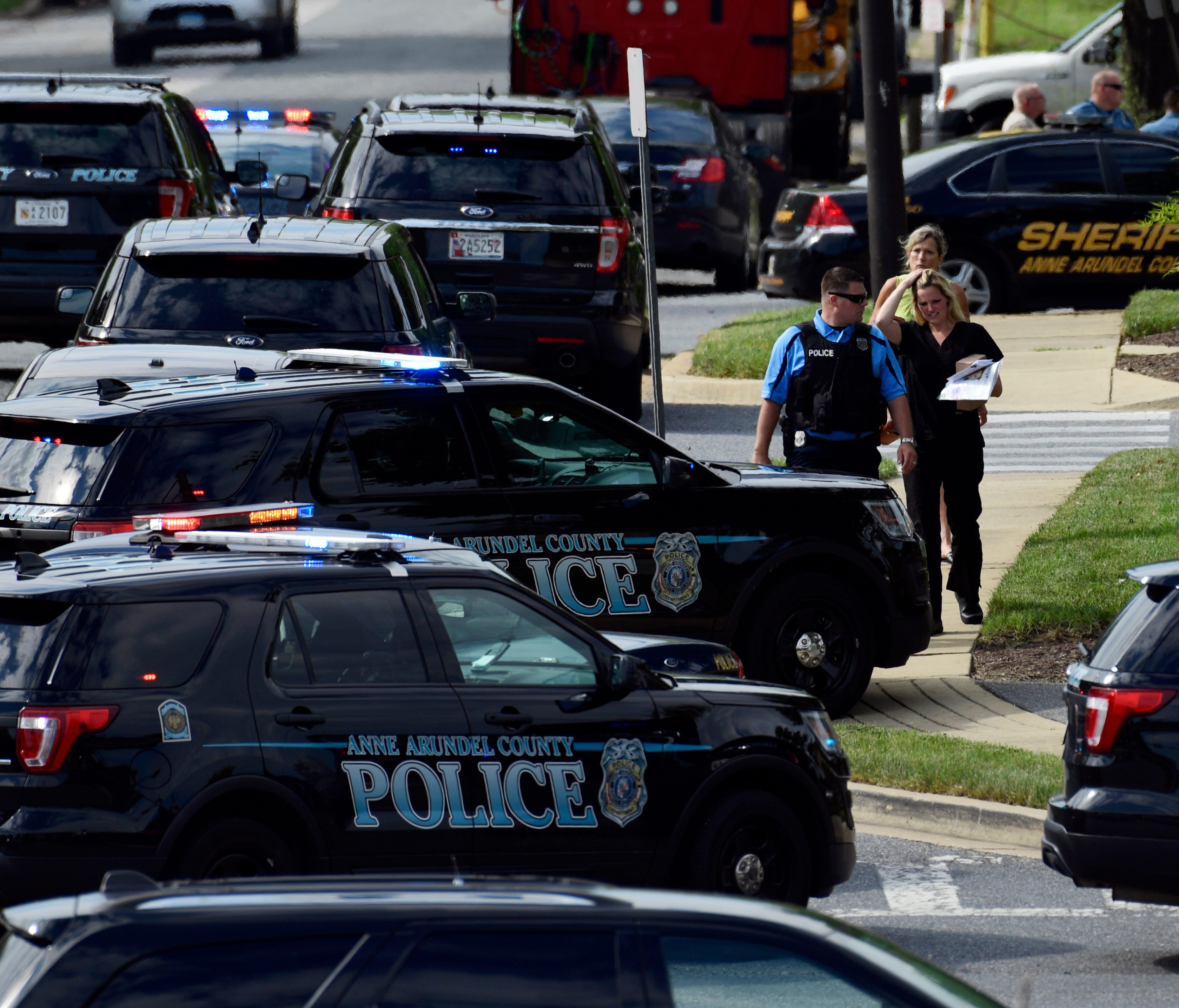 Police secure the scene of a shooting at the building housing The Capital Gazette newspaper in Annapolis, Md., on June 28, 2018.