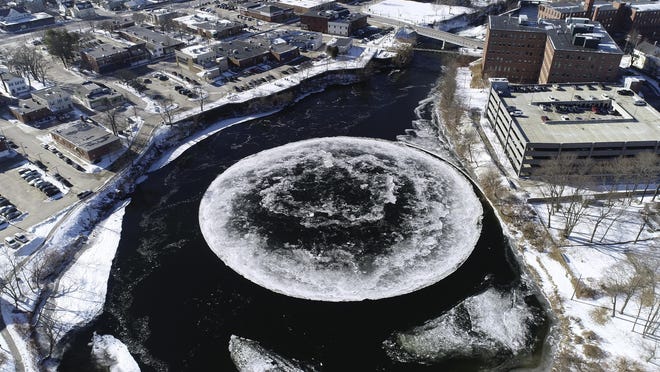 In this Jan. 14, 2019, aerial image taken from a drone video and provided by the City of Westbrook, Maine, a naturally occurring ice disk forms on the Presumpscot River in Westbrook, Maine.