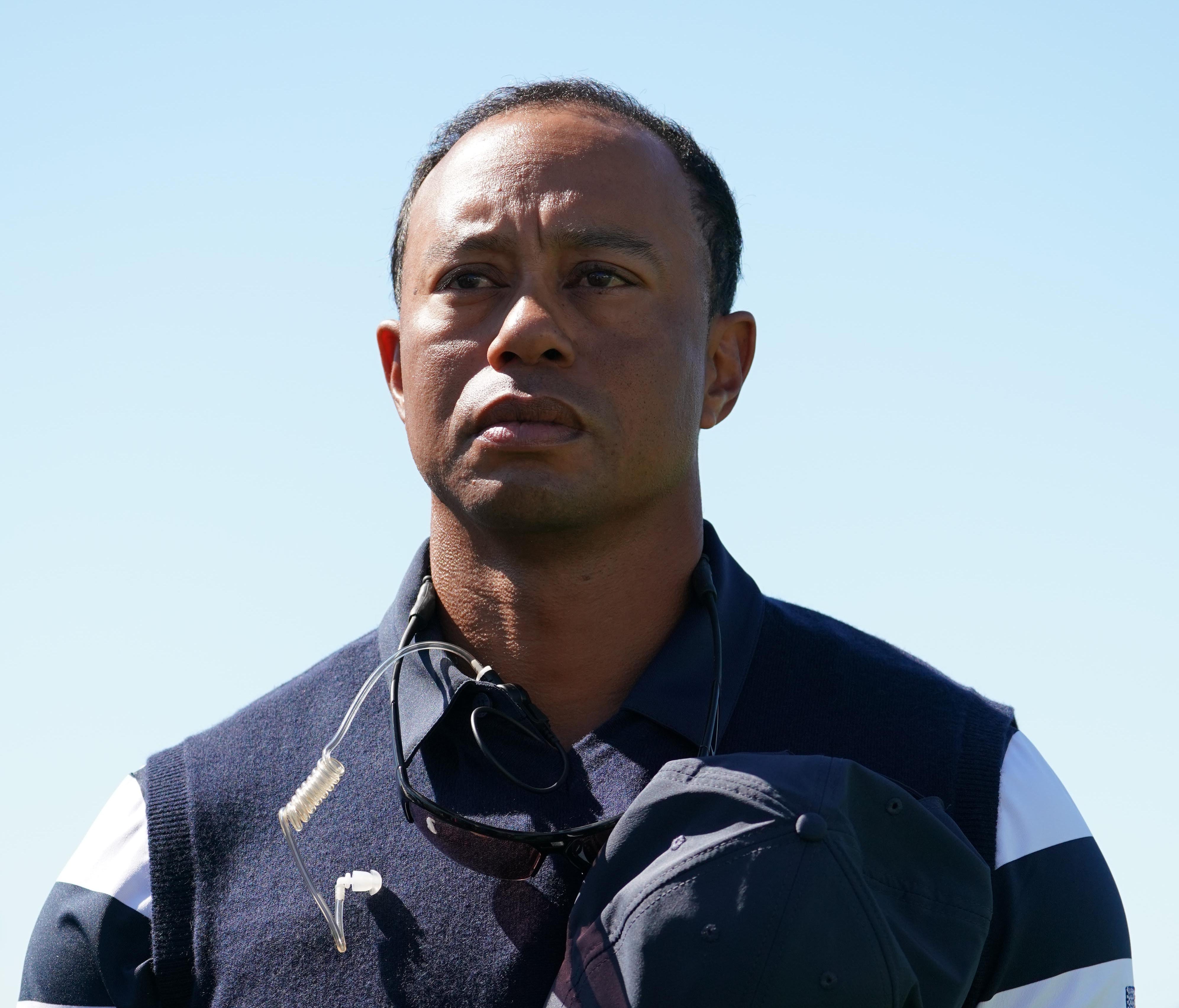 U.S. golfer Tiger Woods stands for the National Anthem before the first round.