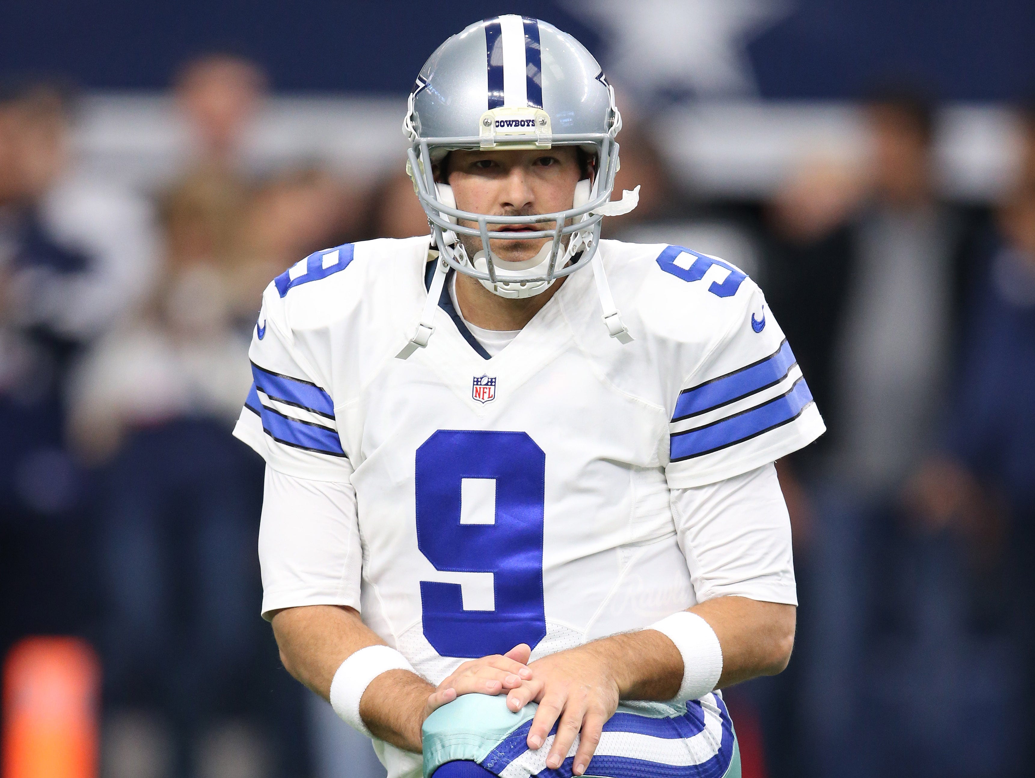 Dallas Cowboys quarterback Tony Romo (9) stretches prior to the game against the Baltimore Ravens at AT&T Stadium.