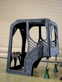 Pictured is an excavator cab made entirely from 3-D printing at the Oak Ridge National Laboratory Manufacturing Demonstration Facility on Saturday. The excavator marks the first large-scale use of steel in 3-D printing.