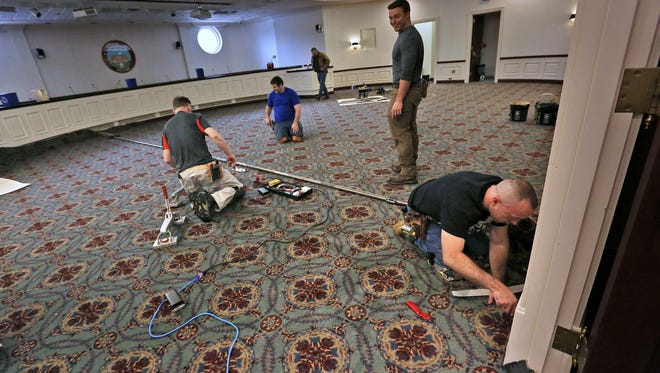 Workmen install new carpet in the Carmel City Hall Council Chambers, 1 Civic Square in Carmel, Friday, Feb. 9, 2018.
