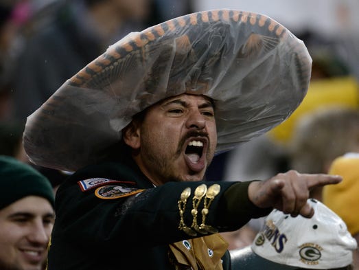 A fan cheers during the first quarter of the Packers-Cowboys
