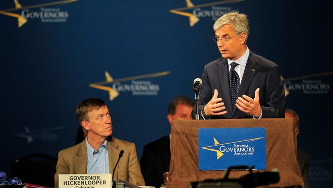 Best Buy CEO Hubert Joly, right, speaks as Colorado Gov. John Hickenlooper looks on during the closing session of the NGA conference at Omni Hotel in Nashville, Tenn., Sunday, July 13, 2014.