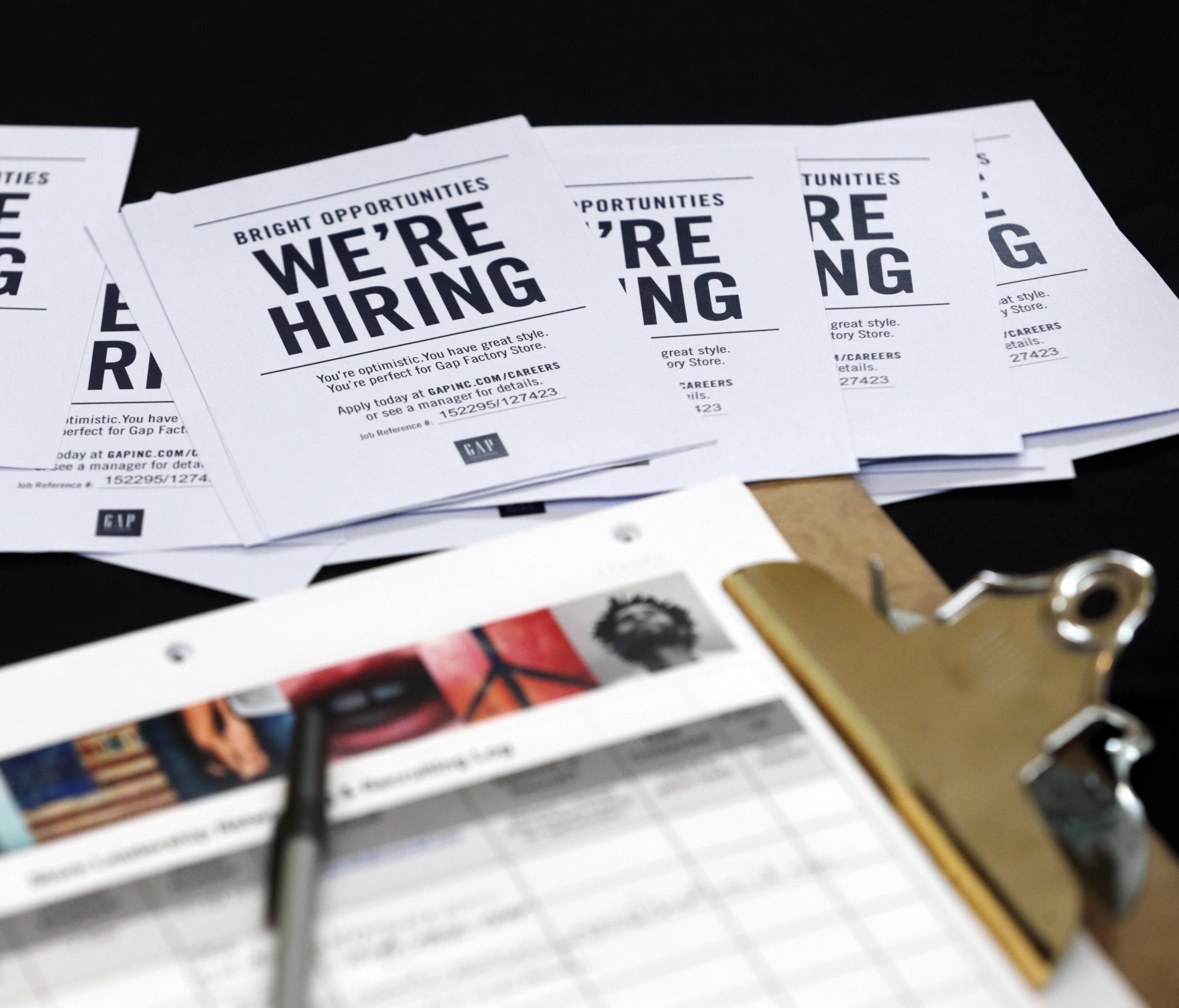 Job applications and information for the Gap Factory Store sit on a table during a job fair at Dolphin Mall in Miami in 2015. As of the latest jobs report, the five fastest-growing sectors in the 12 months prior have been: temporary help, professiona