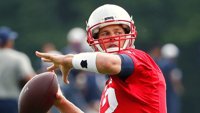 New England Patriots quarterback Tom Brady (12) throws during mini camp at Gillette Stadium.