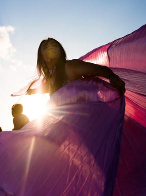 Marguerite Barnett spins in circles, sending her cape into the air during the community drum circle at Siesta Key Beach on Sunday, January 21, 2018 in Sarasota. The weekly tradition started in 1996 and draws a crowd of performers and spectators. 