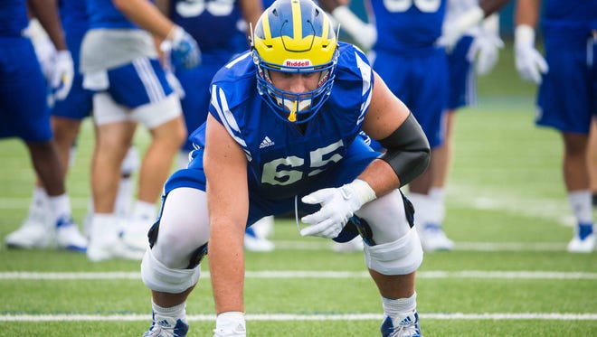 Delaware offensive lineman Noah Beh takes position during practice drills.