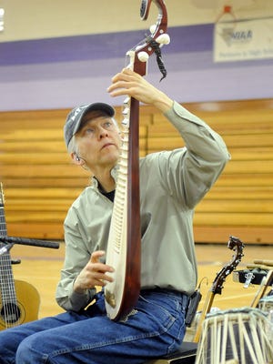 Musician Todd Green plays a Chinese guitar.