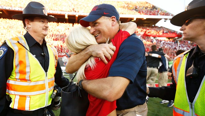 Arizona's Rich Rodriguez hugs his wife Rita after the Wildcats defeated the Sun Devils on Friday, Nov. 28, 2014 in Tucson.