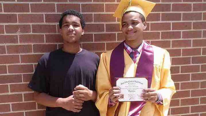 Tarjan "Tray" Edwards (left) and his brother Croshian "CJ" Edwards pose for a photo on graduation day. Police say the brothers were shot and killed during a failed robbery attempt.