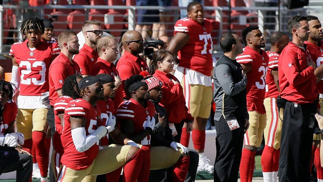 Several 49ers players took a knee during the national anthem on Sunday.