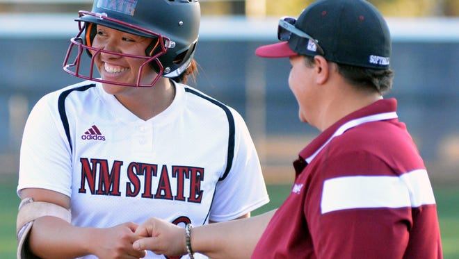 New Mexico State's Haley Nakamura shares a smile at first base after singling during Friday's season opener against Incarnate Word at the NMSU Softball Complex.
