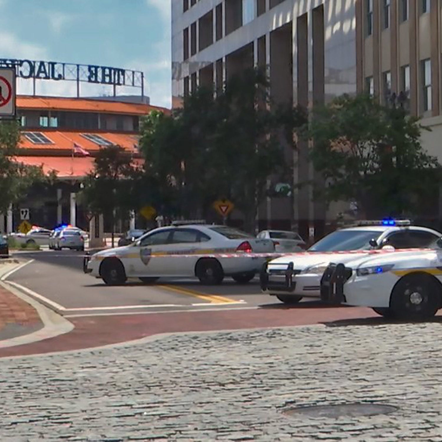 This handout image distributed courtesy of WJXT, a local Jacksonville television station, shows police cars blocking a street leading to the Jacksonville Landing area in downtown Jacksonville, Florida, August 26, 2018. - Several people have been kill