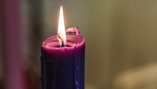 A candle flickers in the sanctuary at First Presbyterian Church,100 N. 10th St., Richmond, in this file photo.