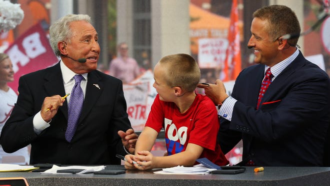 "College GameDay" hosts Lee Corso (left) and Kirk Herbstreit chat with Herbstreit's son, Chase.