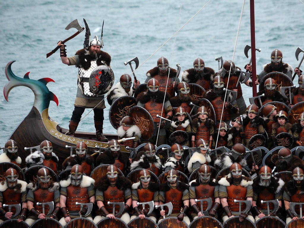 Participants dressed as Vikings pose by a long boat in the annual Up Helly Aa festival in Lerwick, Shetland Islands in the United Kingdom on Jan. 31, 2017.\u000aUp Helly Aa celebrates the influence of the Scandinavian Vikings in the Shetland Islands 