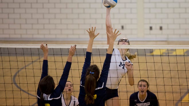 Marysville junior Payton Husson spikes the ball during a volleyball game Tuesday, September 29, 2015 at Port Huron Northern High School.