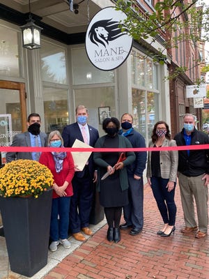Left to right: Phil DeCologero, Executive Director of the Amesbury Chamber of Commerce; Barbara Lorenc, owner of the Trades Mill and member of the Amesbury Chamber Board of Directors; State Representative James Kelcourse; Ashley Casassa, owner of Mane Salon & Spa; Blake Casassa; Amesbury Mayor Kassandra Gove; and Peter Corrigan of Shaheen Bros and member of the Amesbury Chamber Board of Directors celebrate Mane Salon & Spa's new downtown Amesbury location.