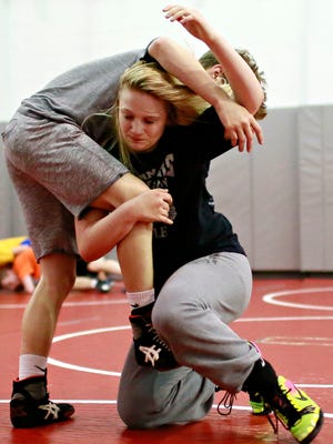 Tiffani McNelis, 14, front, of Stewartstown, and Mason Lewis, 15, of Dover, partner on drills during Modern Day Gladiators Wrestling Club practice at Dover Area High School in Dover, Thursday, May 18, 2017. Dawn J. Sagert photo
