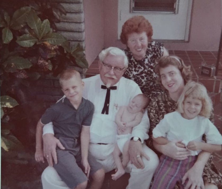 Colonel Harland Sanders poses with daughter Margaret Sanders, great-grandson John Joseph Wurster, baby Harland James Wurster, granddaughter Josephine Wurster and Cindy Wurster. Courtesy of Cindy Wurster Sjogren