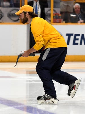 A catfish is removed from the ice during the second period of game 3 in the Stanley Cup Final at Bridgestone Arena Saturday, June 3, 2017, in Nashville, Tenn.