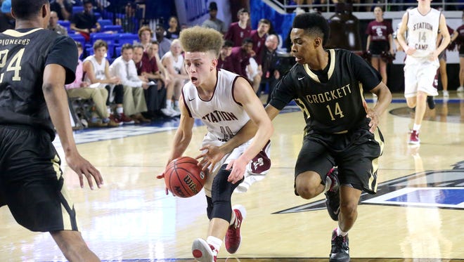 Station Camp's Chase Freeman (11) rushes toward the basket as David Crockett"s Darian Delapp (14) tries to steal the ball during the State Tournament Quarterfinal game Wednesday at MTSU.
